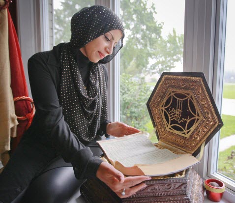 Muslim woman fawning over the Koran