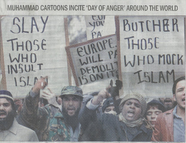 Muslim protesters march towards the Danish embassy in London